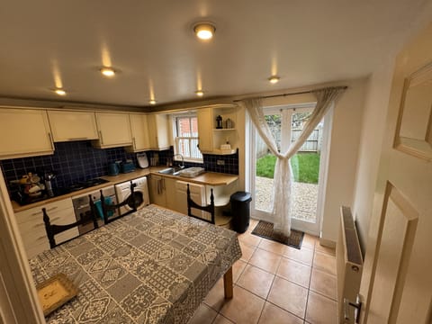 Kitchen with dishwasher, washing machine, Microwave combination oven, gas range.