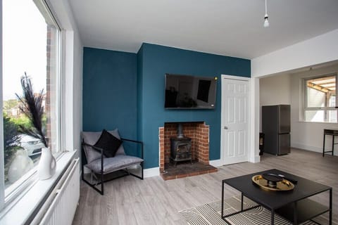 This addition highlights the comfort and style offered by the couch and round glass table in the living room, creating a welcoming atmosphere for guests to relax and enjoy their stay.