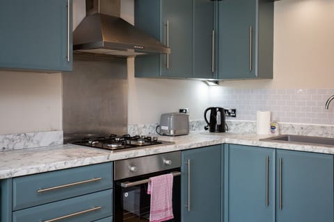 A stylish heat extractor ensures a comfortable cooking environment, while a microwave and toaster provide added convenience for your stay.