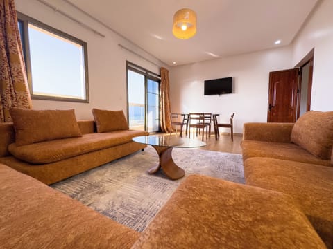 Deluxe Apartment, Non Smoking, Beach View | Living area | 50-inch Smart TV with satellite channels, Netflix, streaming services