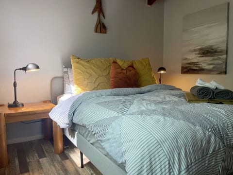 Queen bed with cozy linens.