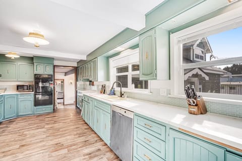 Large kitchen with coffee maker, grinder, microwave, crockpot, blender and serve ware. (3)