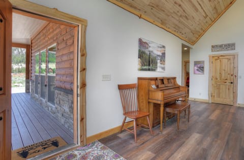 Living room - Mountain Aire VRC Rental Home - Our living room with piano. Front door leads to covered porch.
