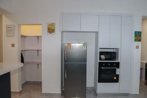 Comfort Apartment | Private kitchen | Fridge, microwave, cookware/dishes/utensils, dining tables