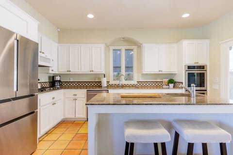 Fully equipped kitchen with high end appliances and bar seating