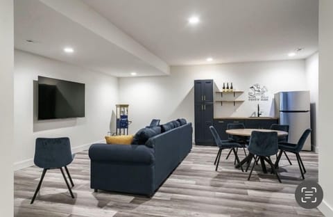 Furnished basement with wet bar and popcorn maker