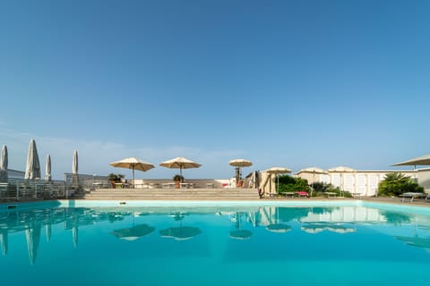 Seasonal outdoor pool, open 9:00 AM to 7:00 PM, pool umbrellas