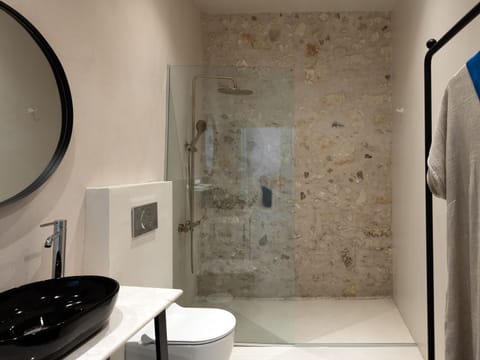 Designer toiletries, hair dryer, slippers, towels