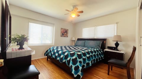 master bedroom with king size bed, LCD TV, radio clock