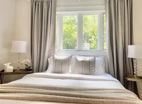 Primary bedroom on main level - attached private bathroom with double vanity.