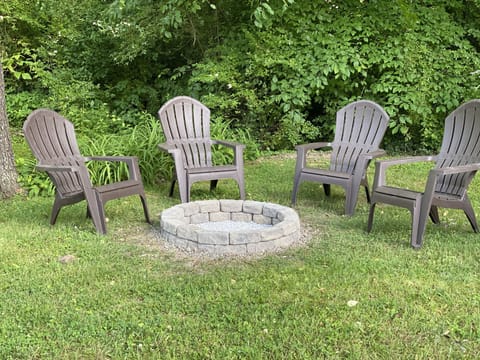 Fire pit located in the backyard by a small creek.
