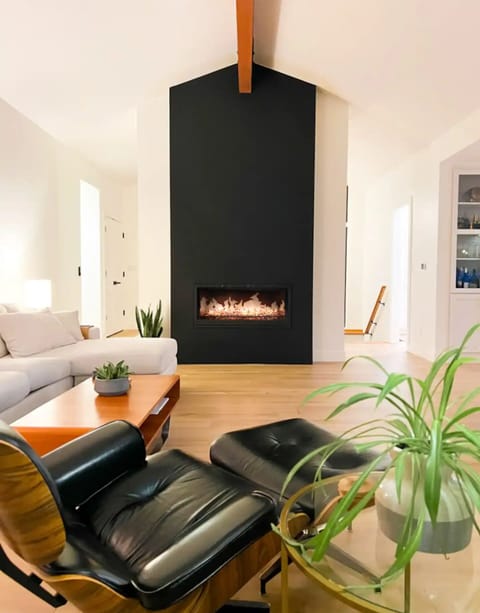 Large living room with TV, fireplace and lots of natural light. 