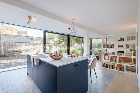 Bright open kitchen with large windows and garden view.