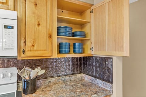 Discover the hidden treasures of the kitchen, with plates and bowls neatly tucked away in one of the cupboards.