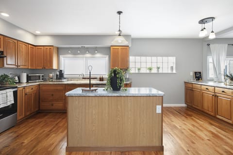 Modern kitchen with island for cooking and socializing.