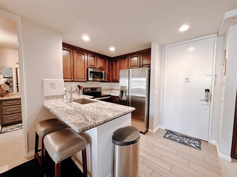 Two additional seats at the kitchen counter offer extra dining space or a spot for casual bites