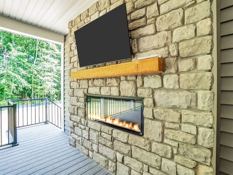 Cover Deck on main level  with TV, couch, fireplace and eating area