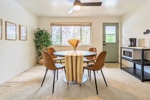 The entire dining area, with its round table, microwave, and coffee maker, is tied together by a consistent design theme. This harmonious blend of furniture and appliances creates a seamless and aesthetically pleasing environment, ideal for both dining an