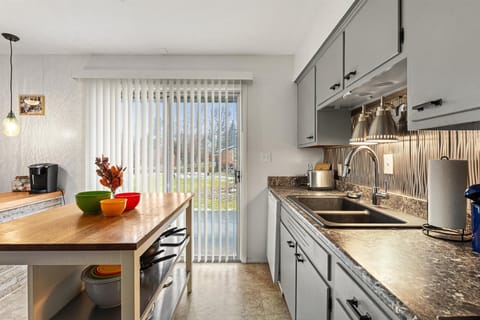Kitchen island counter with pots and pans underneath