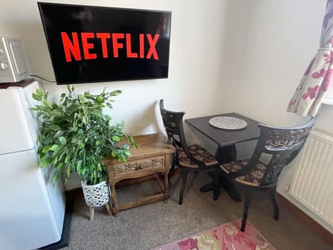 The Living Area: there is a handy table and chairs for you to enjoy a meal on during your visit.