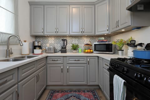 A well-equipped kitchen featuring elegant grey cabinets