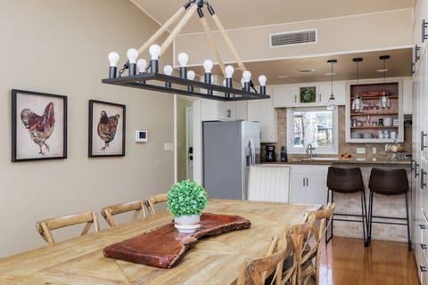 Enjoy memorable dining experiences in the welcoming ambiance of the dining area, featuring a beautiful wood table, stylish chairs, and plenty of natural light.