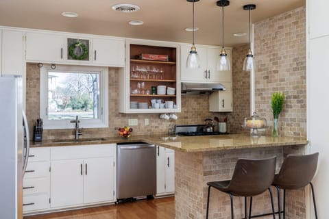 Experience the joy of cooking in the modern kitchen, equipped with top-of-the-line appliances, a spacious island, and everything you need for gourmet meals