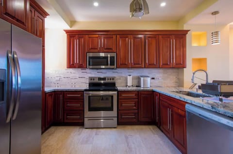 Deluxe Condo | Private kitchen | Full-size fridge, microwave, oven, stovetop