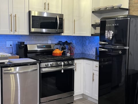 Gas range, tea kettle, and fancy blue lights.