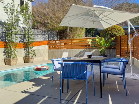Heated Pool with Outdoor Dining Table, Lounge Chairs, and Pool Bathroom
