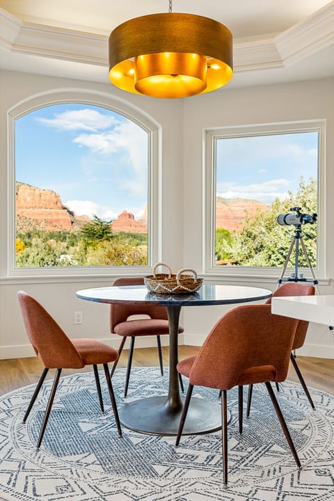 - Cozy Sedona breakfast nook with round table and warm seating - Large windows showcase beautiful desert scenery outside - Peaceful spot perfect for morning coffee and relaxation