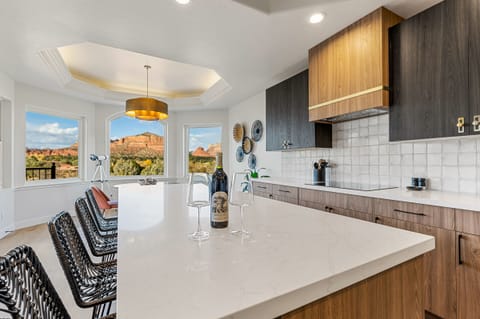 - Sedona kitchen with stunning red rock window views - Large island seating and modern cabinetry create comfort - Bright space perfect for cooking and relaxing moments