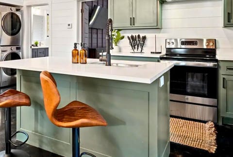 Modern kitchen features a convenient breakfast bar with stylish stools