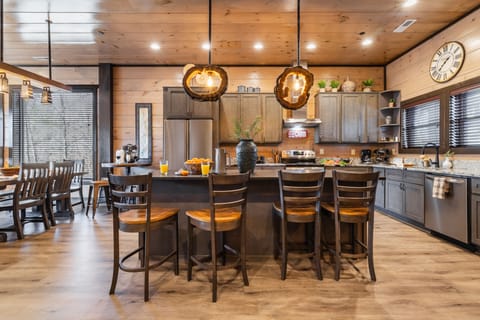Kitchen features an island with barstool seating.