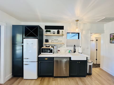 Gorgeous kitchen with vintage style fridge, farmhouse sink & quartz countertops