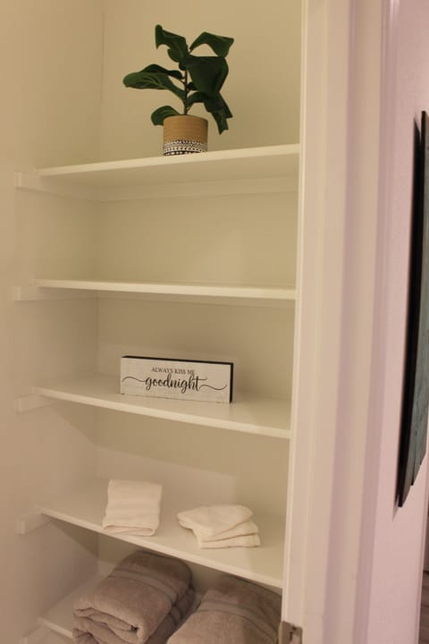 As you walk into the downstairs primary bathroom 1, there are shelves.