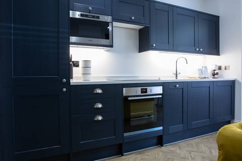 Fully equipped kitchen with fridge freezer, washing machine, dishwasher, microwave, oven and hob.