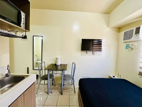 Standard Condo | Private kitchenette | Mini-fridge, microwave, electric kettle, dining tables