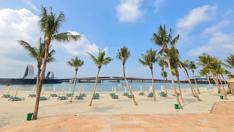 On the beach, white sand, sun loungers, beach umbrellas