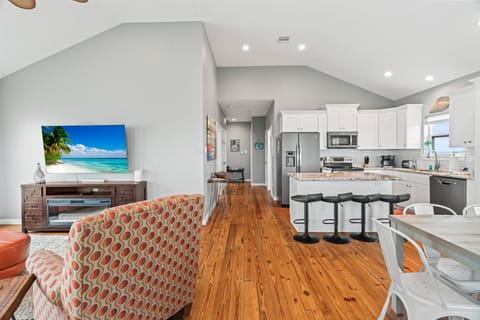 As you enter the home take in the view of the living room, kitchen and dining space.