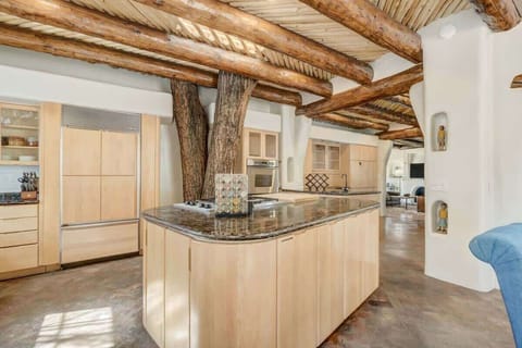 With a center island fit for a feast, a fully stocked kitchen that's ready to rumble, and a live tree adding some extra flair, it's a culinary adventure waiting to happen.