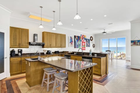 Dixie Tides kitchen is fully equipped, featuring stone counters and stainless appliances