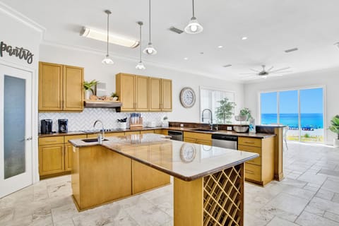 Hammock Dunes East spacious kitchen offers stone counters and stainless appliances