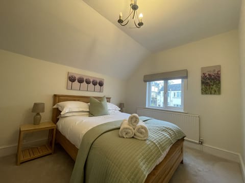 This bedroom is furnished with double bed, wardrobe and bedside tables