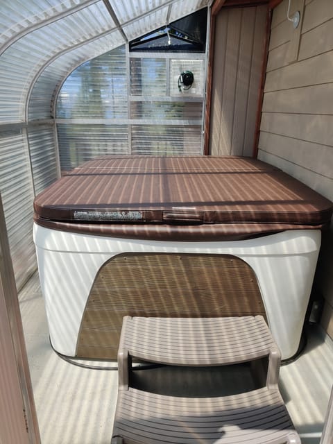 Hot tub located in solarium doubling as a sauna!