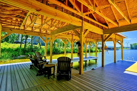 Spacious covered dock with seating area, perfect for relaxing by the water and enjoying the view