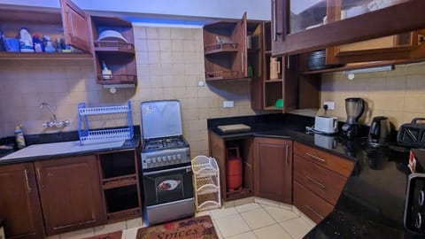 Family Apartment | Private kitchen | Fridge, microwave, cookware/dishes/utensils, dining tables