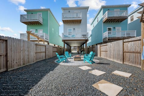 Backyard space complete with fire pit, lounge chairs and hammocks.