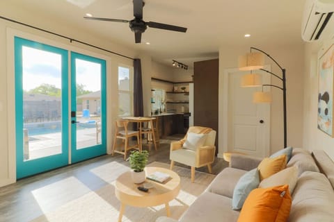 Sun-drenched living room with generous natural light, offering a relaxing start to your day. For those seeking extra rest, tall curtains provide blackout comfort.