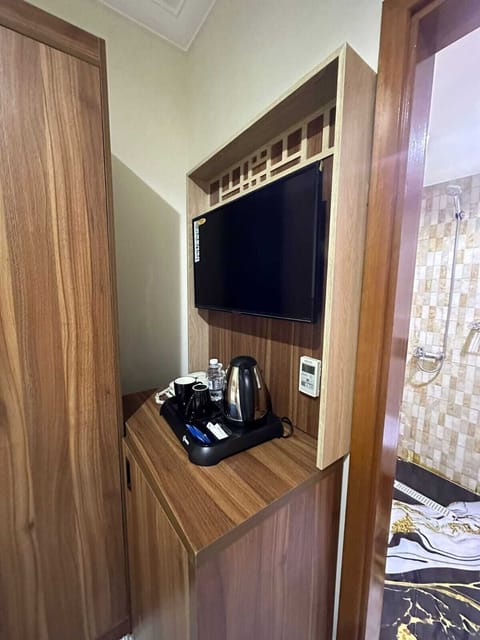 Standard Triple Room | Living area | Flat-screen TV